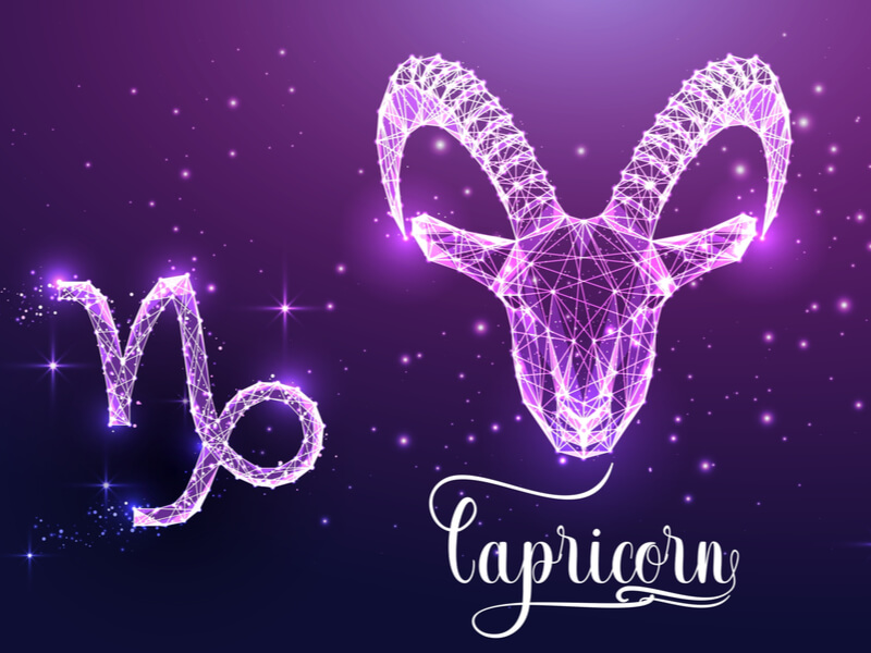 Símbolos do signo de Capricórnio no fundo roxo