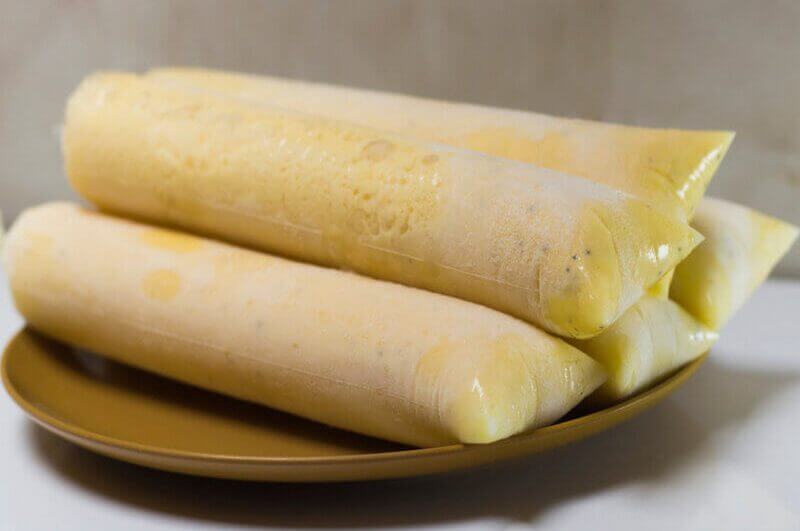 Prato dourado com geladinhos de maracujá empilhados