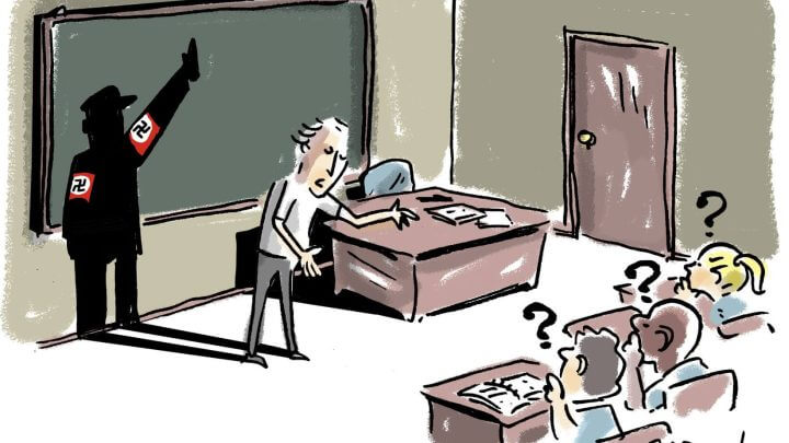 A imagem é uma representação do vídeo que viralizou. A cena é em uma sala de aula onde o professor aparece em pé falando e a sua sombra é de um soldado nazista, com o símbolo da suástica nos braços. Os alunos estão sentados nas carteiras com pontos de interrogação em suas cabeças.