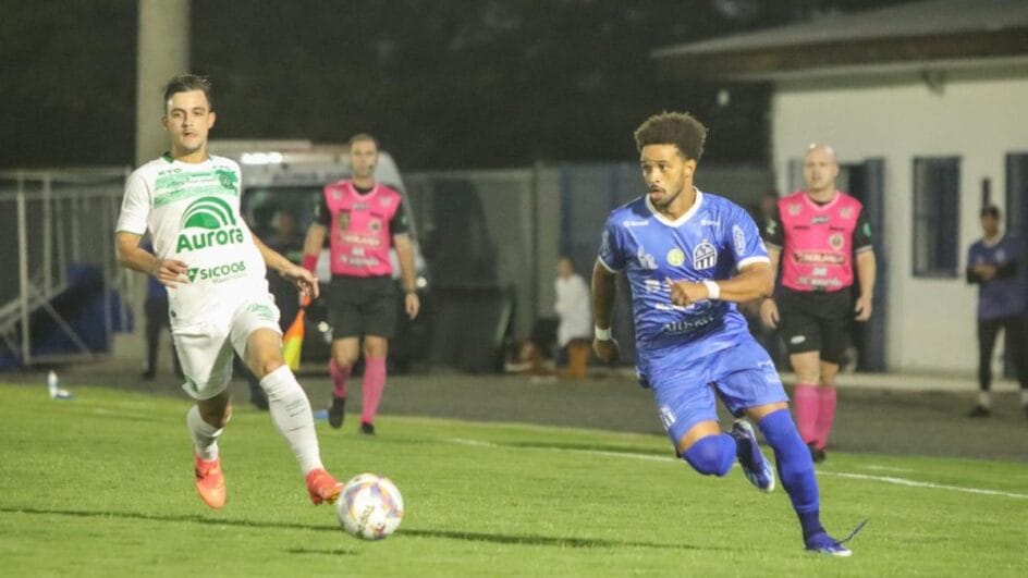 Imagem mostra jogador do Caravaggio com a bola dominada e jogador da Chapecoense ao lado