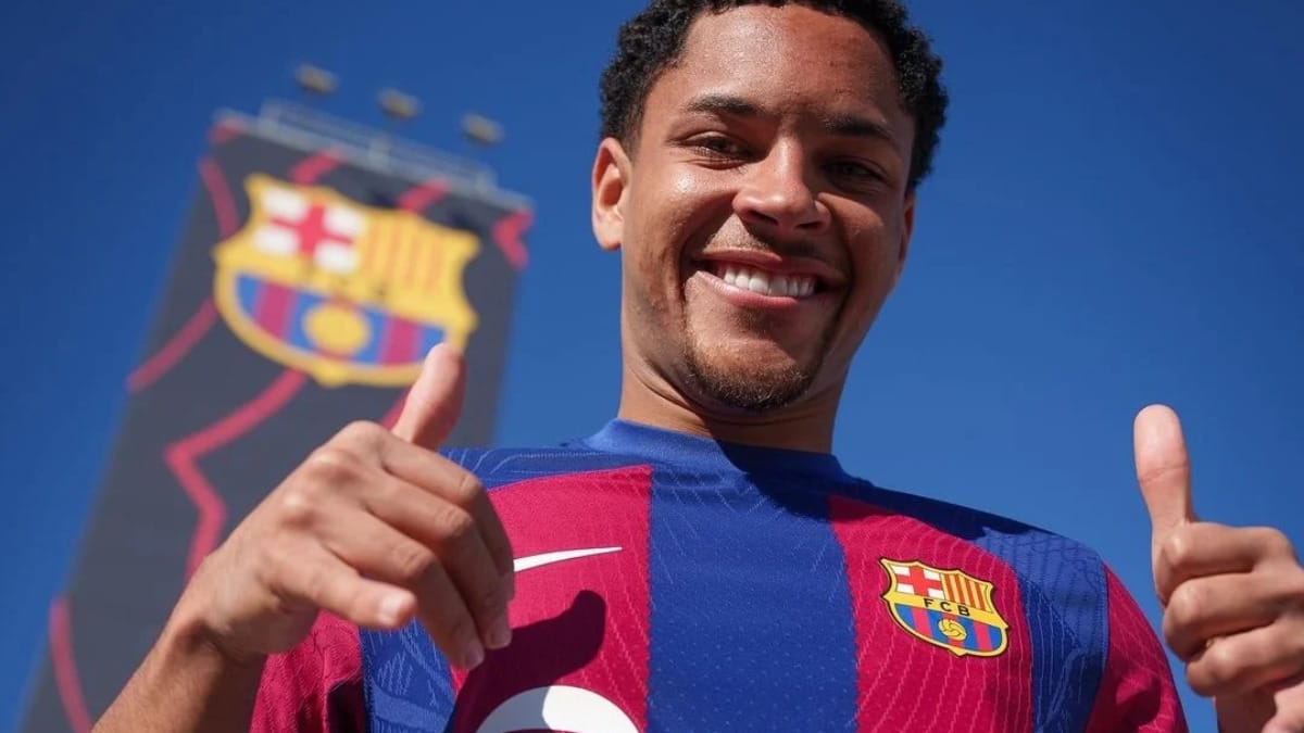 Imagem mostra Vitor Roque com a camisa do Barcelona e ao fundo o escudo no lado esquerdo da foto