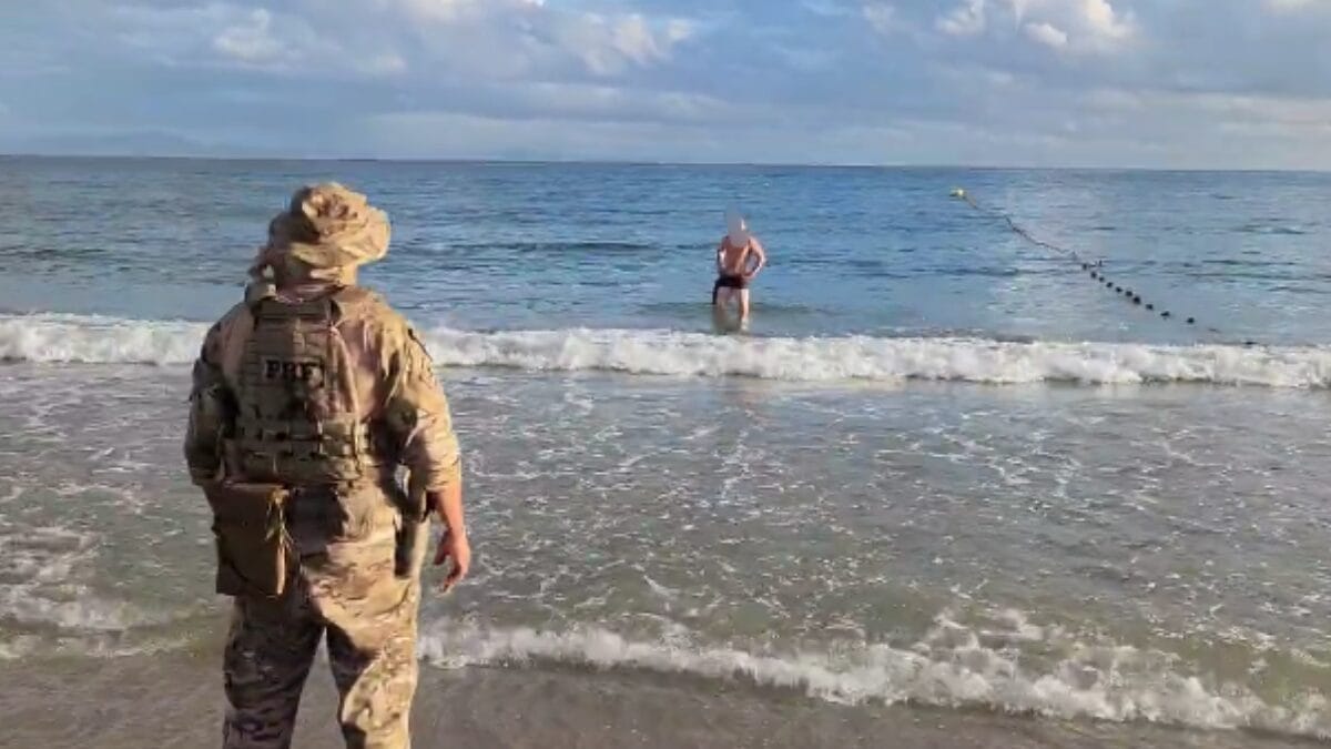 Homem ainda demorou para sair da água após nadar de volta para a faixa de areia (Foto: PRF, Reprodução)