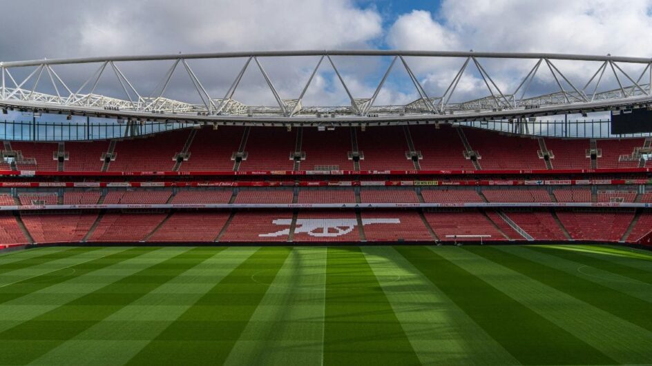 Imagem mostra arquibancada e gramado do estádio do Arsenal e o céu com nuvens
