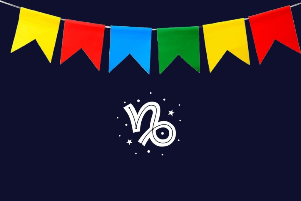 Ilustração do signo de Capricórnio com traço branco curvado em formato de gancho, sobre fundo azul-escuro e bandeirinhas coloridas