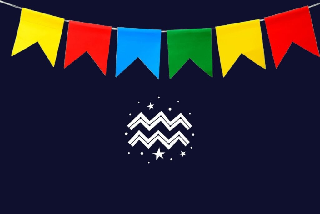 Ilustração do signo de Aquário com duas linhas em zigue-zague brancas, fundo azul-escuro e bandeirinhas coloridas em amarelo, vermelho, azul e verde