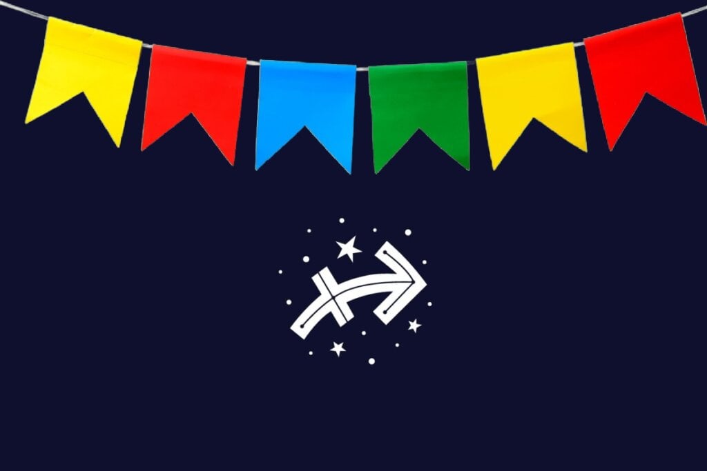 Ilustração do signo de Sagitário com seta branca apontando para cima e direita, fundo azul-escuro e bandeirinhas verde, amarela, vermelha e azul