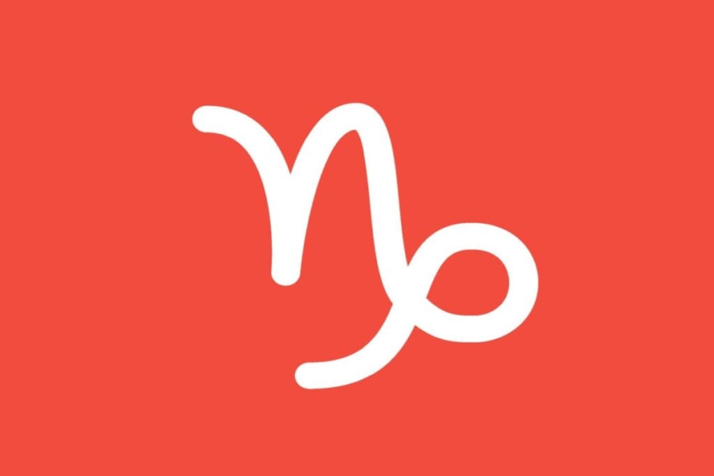 Ilustração branca do signo de capricórnio em fundo de cor salmão