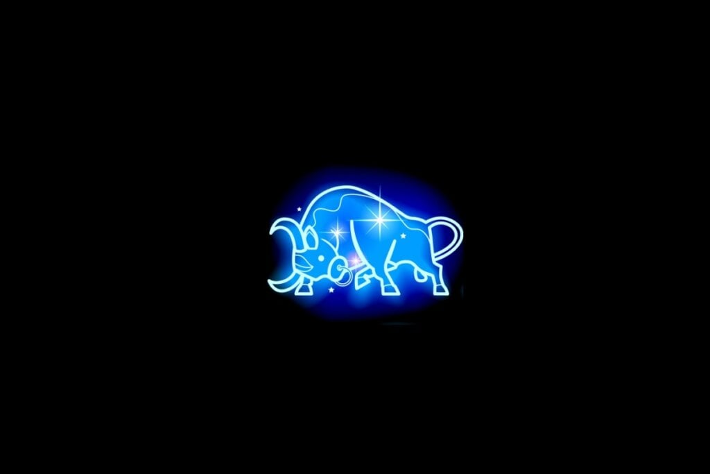 Ilustração do signo de touro em azul sobre um fundo preto