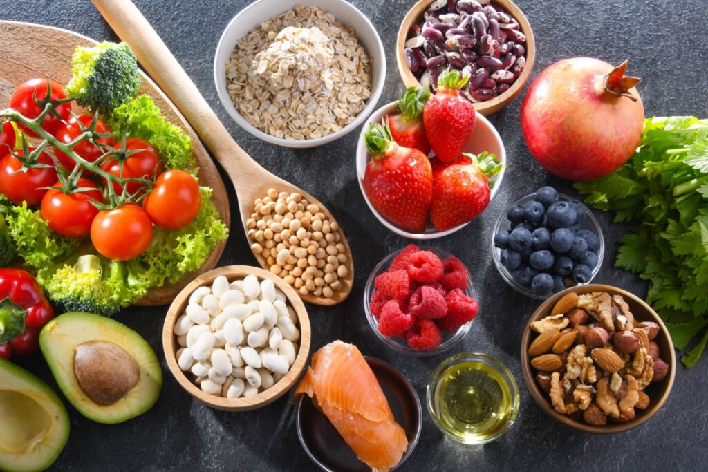 Mesa com morangos, mirtilo, framboesa, vegetais, tomates, oleaginosas