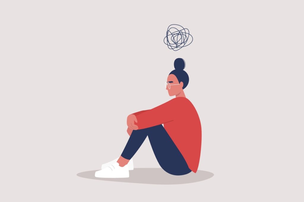 IlustraÃ§Ã£o de uma jovem sentada no chÃ£o usando sapato branco, calÃ§a preta e blusa vermelha e com um circulo de rabisco em cima da cabeÃ§a em fundo cinza