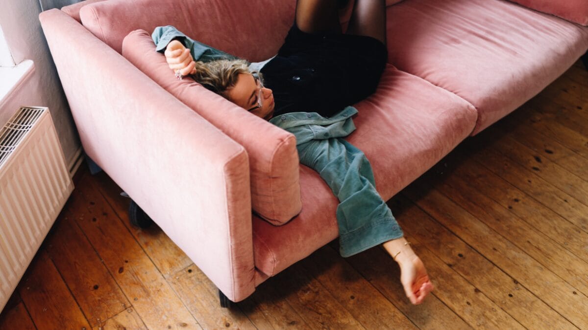 Mulher cansada jogada no sofá