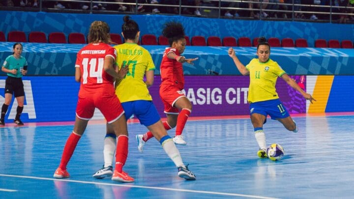 Atleta do Brasil chutando a bola para o gol na Copa do Mundo de Futsal Feminino