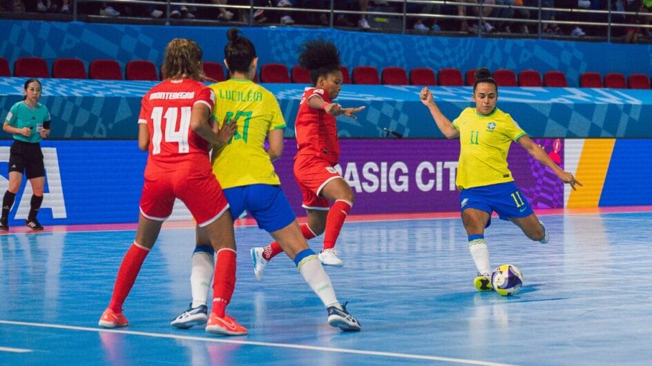 Atleta do Brasil chutando a bola para o gol na Copa do Mundo de Futsal Feminino