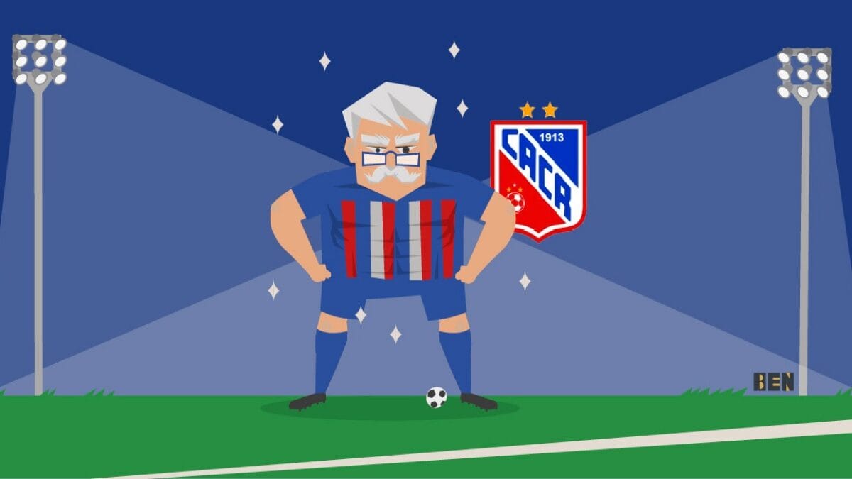 Arte de um Vov&ocirc;, o mascote do Carlos Renaux, no campo com o uniforme, uma bola no p&eacute; e o escudo do clube ao lado