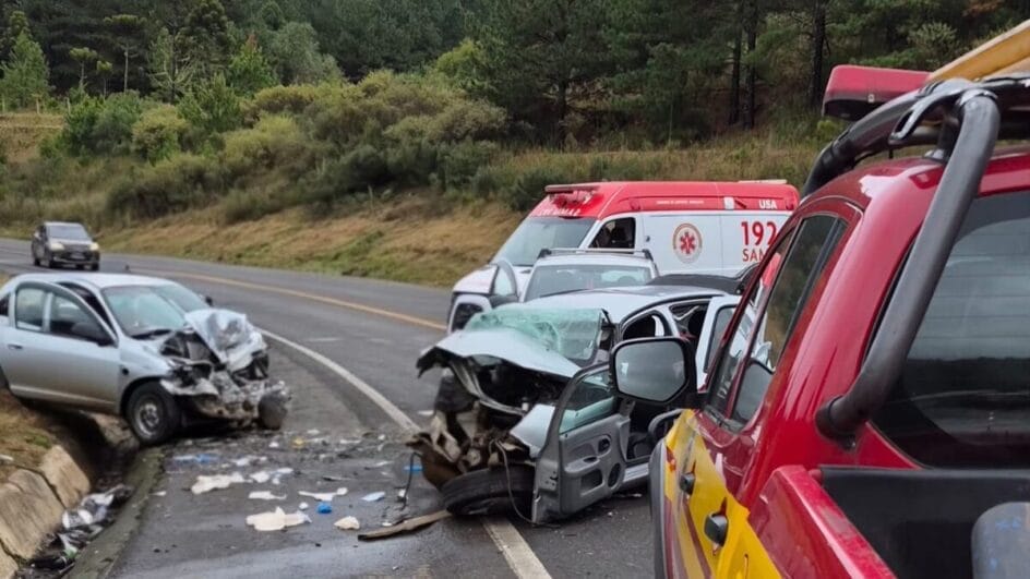 carros de cor prata completamente destruídos por acidentes, ao lado de ambulância