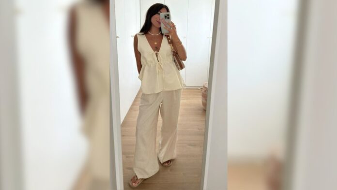 mulher com calça e bata branca
