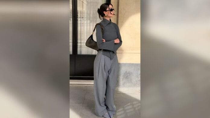 mulher com blusa e calça cinza