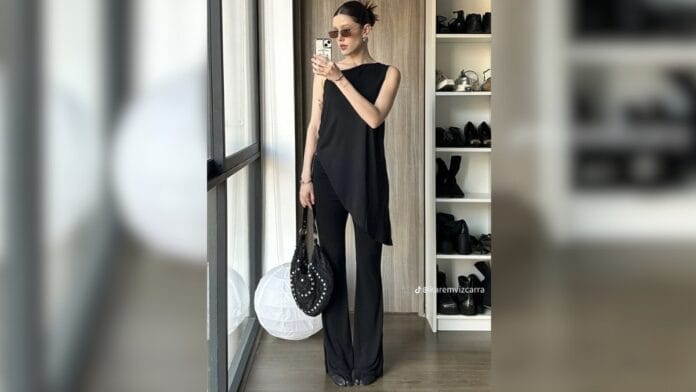mulher com blusa e calça preta