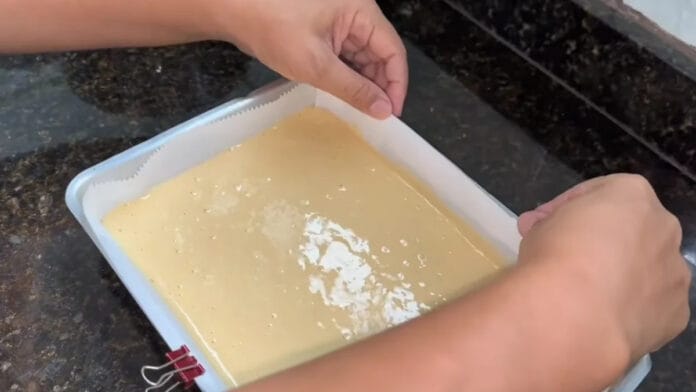 adicionando a massa do rocambole na forma